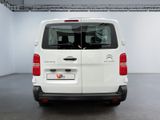 the rear of a white van parked inside of a building
