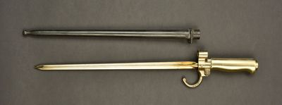 an image of a sword and a hook on a table