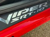 a close up of a red car with a logo on it