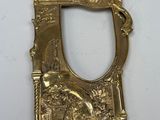 a close up of a gold plate with a mirror on it