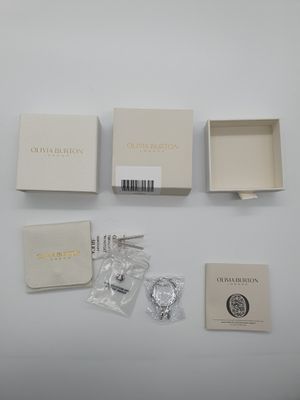 the contents of a watch are laid out on a white surface