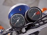 two gauges on the handlebars of a motorcycle