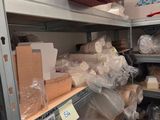 many boxes and containers on the shelves in the room
