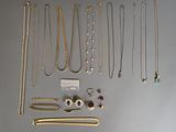 a lot of necklaces and bracelets laid out on a table
