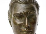 bronze bust of a man with a serious look on his face