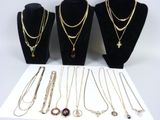 several necklaces and bracelets are displayed on display on a table