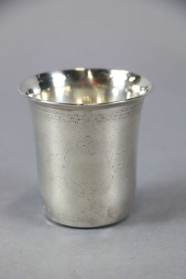 a silver cup that is sitting on a table