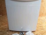a picture of a toilet with a toilet paper dispenser on the floor