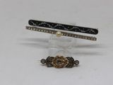 three different types of hair clips on a white surface