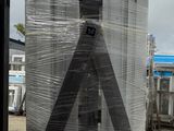 an image of a man standing in front of a metal structure