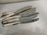 a lot of knives that are sitting on a table