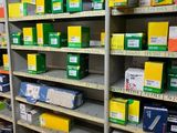 boxes and packages are stacked on a shelf in a store