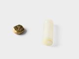 a small plastic tube next to a small plastic tube