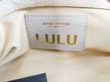 the inside of a white purse with a name tag on it