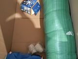 a cardboard box with a mattress and a blanket inside of it