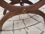 a wooden bench sitting on the side of a brick road