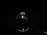 an image of a glass ball on a reflective surface