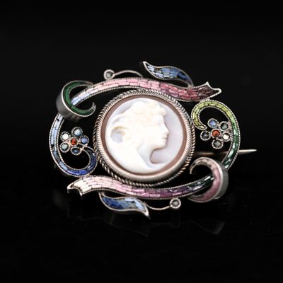 a close up of a broochle with a woman ' s face in it