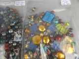 two bags of glass beads and a bag of plastic beads