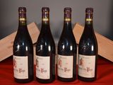 three bottles of red wine sitting next to a wooden box