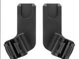 une paire de supports en plastique noir pour appareil photo sur fond blanc
