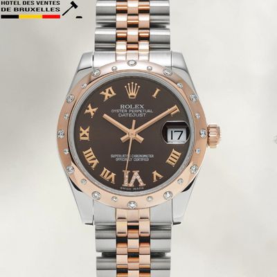 rolex watch with black dial and roman numerals on bracelet