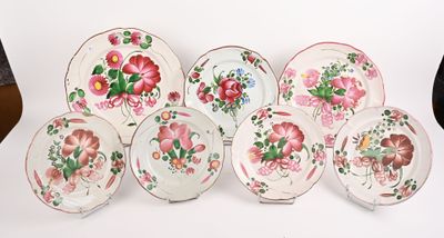 plusieurs assiettes ornées de motifs floraux, posées sur une surface blanche
