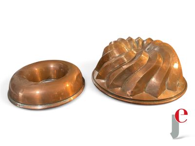 two chocolate bundts sitting on a plate next to each other
