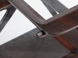 a close up of a wooden chair with a metal frame