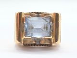 an image of a gold ring with a blue stone in the center