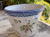a blue and white flower pot sitting on a table