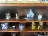 a wooden shelf with a bunch of figurines on top of it