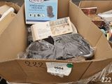 a cardboard box full of items for sale on the street