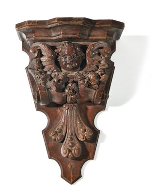 a close up of a wooden wall mounted on a white wall
