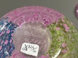 a glass ball with a sticker on it sitting on a table
