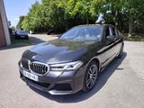 bmw m90 xdrive in a parking lot with trees in the background