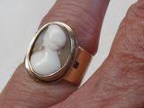 la main d'une femme tenant une bague sertie d'une pierre blanche