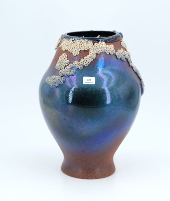 a blue vase with a brown and blue design on it