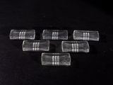 six clear glass squares with a black and white stripe on them