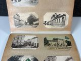 an old photo of an open book with pictures of buildings on it