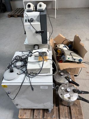 a pile of appliances sitting on a pallet in a room