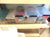 a refrigerator filled with plastic containers and plastic bins