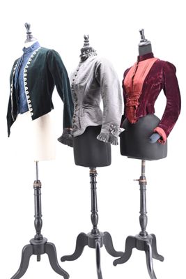 three mannequins that are on display on a stand