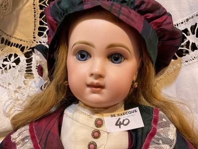 a close up of a doll with a tag on it