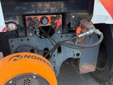 a machine that is sitting on the ground next to a truck
