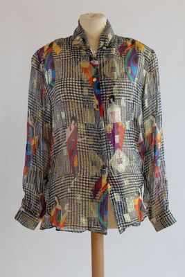 an image of a woman ' s shirt on a mannequin stand