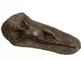 bronze sculpture of a woman laying on a leaf
