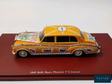 a toy car that is on display on a red surface