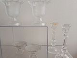 three glass vases sitting on a shelf in a room