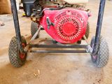 a small engine on a cart in a garage